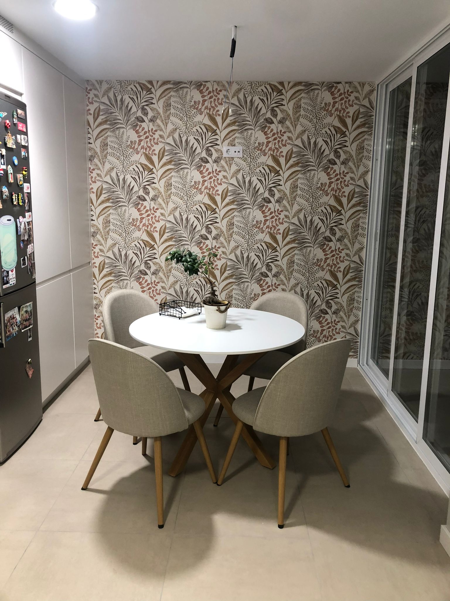 Comedor reformado con papel pintado decorativo y mobiliario moderno